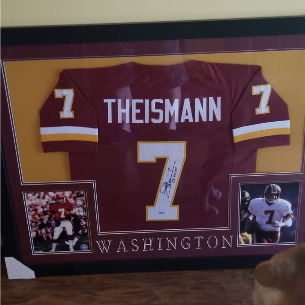 Joe Theismann signed and framed football jersey.